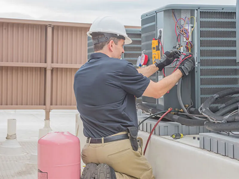 Professional AC repair and diagnostics on commercial HVAC unit in Montgomery County IL